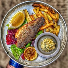 A picture of Lemon & Black Pepper Sea Bass w / Garlic Fries.