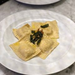 A picture of Homemade crab ravioli with sage lemon butter sauce.