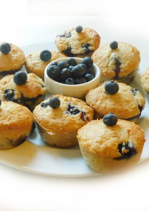 A picture of COCONUT MUFFINS with blue berries and chocolate chips.