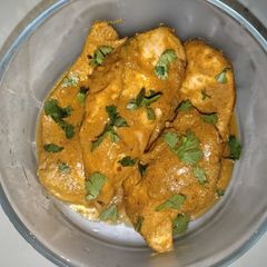 A picture of Spiced Carrot Velouté Chicken Topped with Cilantro.