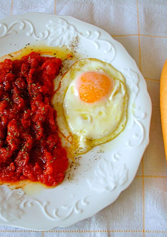 Una foto de Tomates Daniela confitados con huevos fritosa la tapa