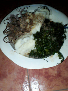 A picture of Ugali served with sukuma and beef.