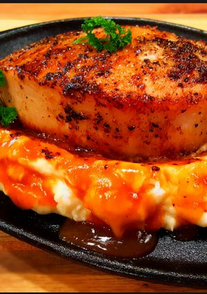 A picture of Mike's Thick Cut Top Loin Pork Chops Over Mashed Potatoes.