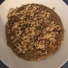 A picture of Legume and grain soup with tahini sauce.