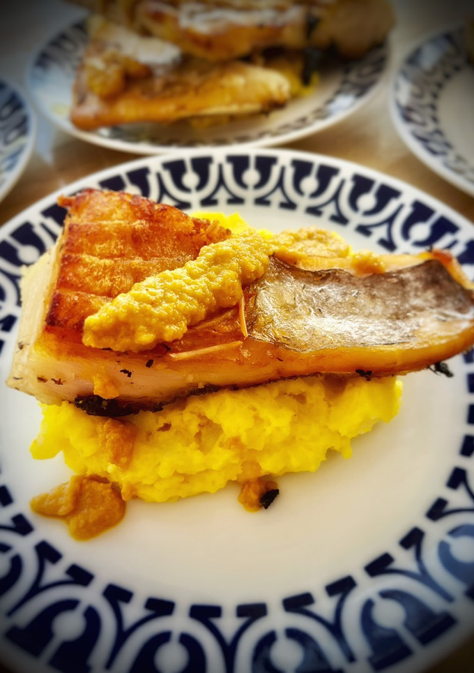 Una foto de Bacalao sobre parmentier al azafrán con crema de naranja