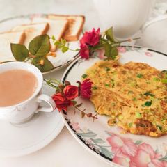 A picture of Spring Onion omellete ! Sandwich ! With hot tea ☕.