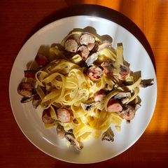 A picture of Fettucine with sausage and mushroom.