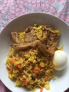 A picture of Spicy noodles with lamb chops.