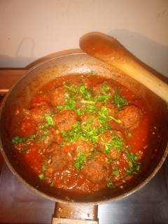 A picture of Meatballs in sauce.