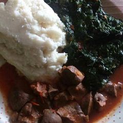 A picture of Liver stew and ugali served with veges.