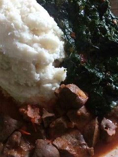 A picture of Liver stew and ugali served with veges.