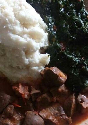 A picture of Liver stew and ugali served with veges.
