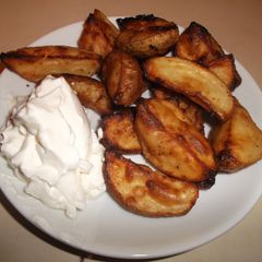 A picture of Seasoned Potato Wedges with Sour Cream.