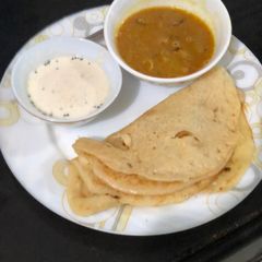 A picture of Pumpkin Uttapam, sambhar and chutney.