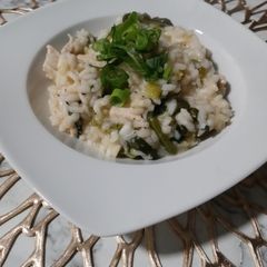A picture of Risotto with lemon, chicken and spinach.