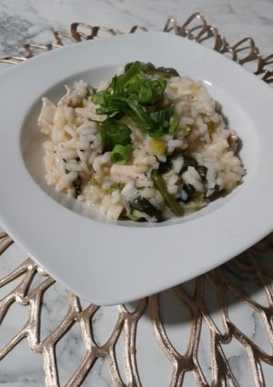 A picture of Risotto with lemon, chicken and spinach.