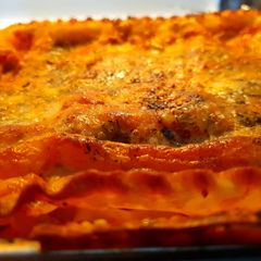 A picture of Cheese lasagna with vegan meatballs.