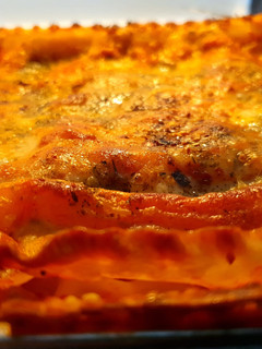 A picture of Cheese lasagna with vegan meatballs.