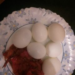 Boiled eggs and garlic tomato sauce A picture of Boiled eggs and garlic tomato sauce.