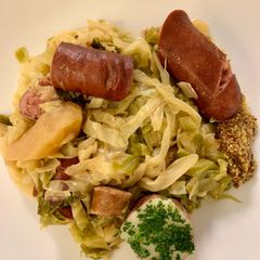 A picture of Cabbage with Sausages (Choucroute Garnie or Sauerkraut with Sausages).