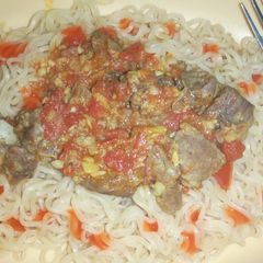 A picture of Indomie noodles and beef stew.
