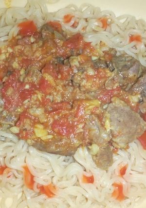 A picture of Indomie noodles and beef stew.