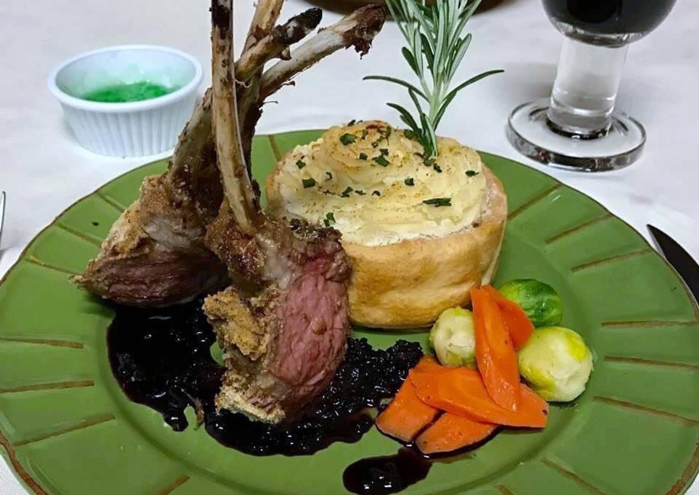 Rack of lamb with red wine sauce, garlic mashed potatoes, Brussels sprouts and carrots