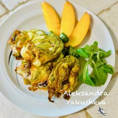 A picture of Stuffed zucchini flowers.