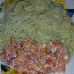 A picture of Indomie noodles with fried eggs.