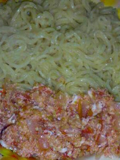 A picture of Indomie noodles with fried eggs.