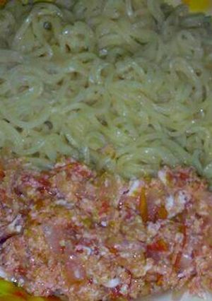 A picture of Indomie noodles with fried eggs.