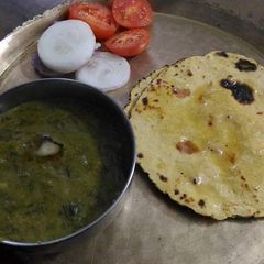 A picture of Sarso ka saag and makki Di roti.