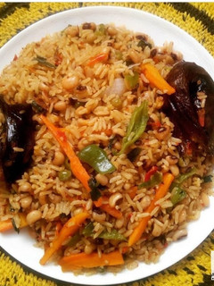 A picture of Jollof rice and beans with veggies.