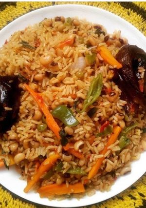 A picture of Jollof rice and beans with veggies.