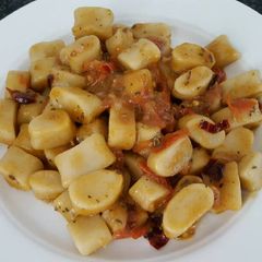 A picture of Gnocchi in chili tomato sauce.