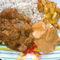 A picture of Native sauce, Ofada rice, moi moi and plantain.