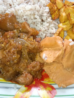 A picture of Native sauce, Ofada rice, moi moi and plantain.