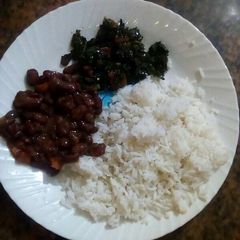 A picture of Plain rice with beans and kales.