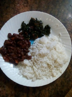 A picture of Plain rice with beans and kales.
