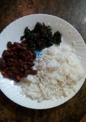 A picture of Plain rice with beans and kales.