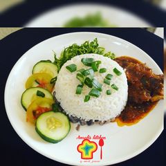 A picture of Rice and beans with stew.