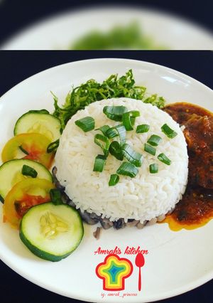 A picture of Rice and beans with stew.
