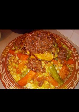 A picture of Moroccan Couscous with Chicken, Tfaya, and Vegetables.