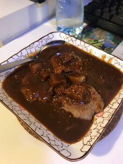 A picture of Pork patty with curry sauce.