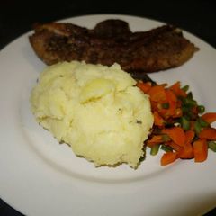A picture of Mashed potatoes with herbs.