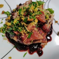 A picture of Roast pork with blueberry balsamic sauce and pistachio gremolata.