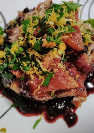 A picture of Roast pork with blueberry balsamic sauce and pistachio gremolata.