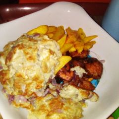A picture of Fried Irish Potatoes and plantain with fried egg.