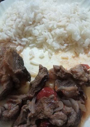 A picture of Beef stew served with Rice.