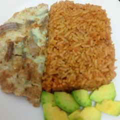 Jollof rice with fried egg and avacado A picture of Jollof rice with fried egg and avacado.